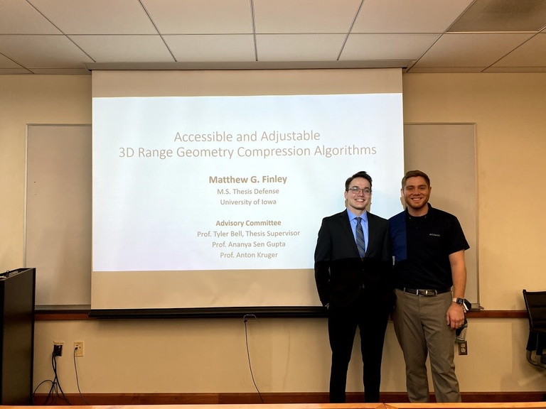 Matthew Finley and Tyler Bell pose for a photo at Matthew's thesis defense