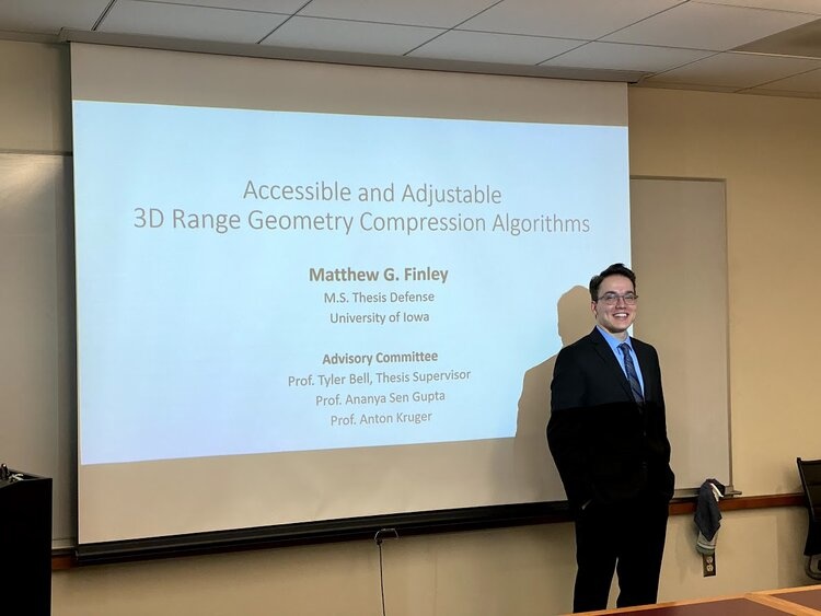 Matthew Finley poses for a photo at his thesis defense