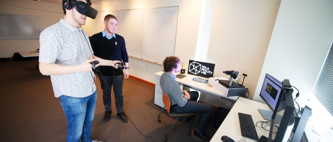 A student wearing a virtual reality headset in the lab