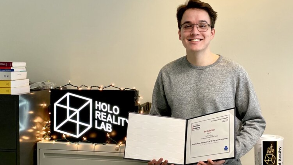 Jacob Finley poses with his award certificate