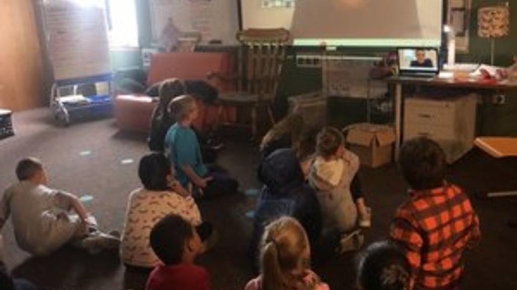 Tyler Bell talks to an elementary school class via video